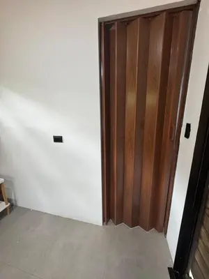 a room with a wooden door and a white wall at Tiny House Surf Nature and Relaxation in Playa Negra