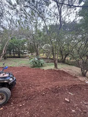 a dirt area with a motorcycle parked in a forest at Tiny House Surf Nature and Relaxation in Playa Negra