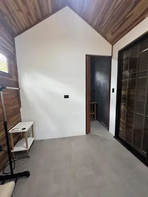 a room with a white wall and a door at Tiny House Surf Nature and Relaxation in Playa Negra