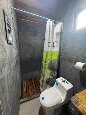 a bathroom with a toilet and a shower at Tiny House Surf Nature and Relaxation in Playa Negra