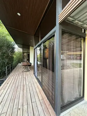 a wooden deck with glass doors on a house at Bamboo grove villa in San Isidro