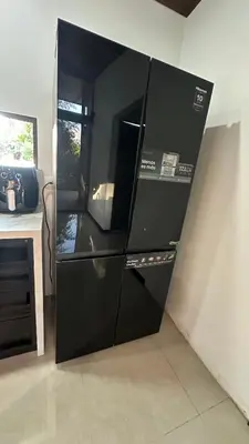 a black refrigerator sitting next to a counter in a kitchen at Bamboo grove villa in San Isidro