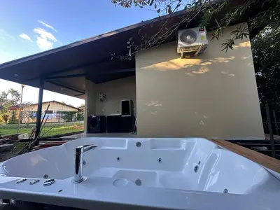 a bath tub with a fan on the side of a house at Bamboo grove villa in San Isidro