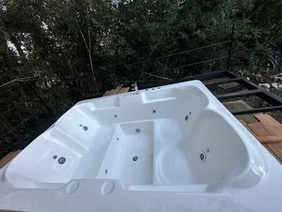 a white bath tub sitting on top of a deck at Bamboo grove villa in San Isidro
