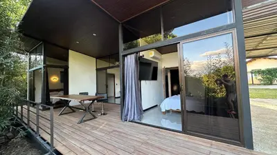 a glass house with a view of a bedroom at Bamboo grove villa in San Isidro
