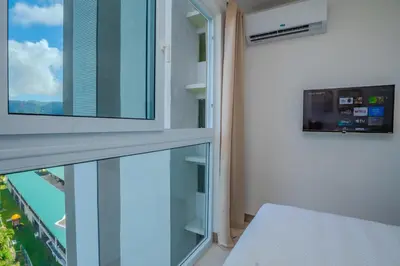 a room with a balcony with a view of the city at Panoramic ocean view condo-pools-gym-fast internet in Jacó