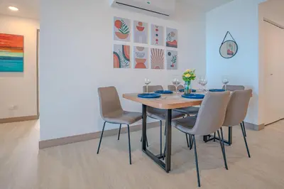 a dining room with a table and chairs at Panoramic ocean view condo-pools-gym-fast internet in Jacó