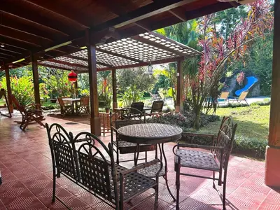 a patio with a table and chairs under a pavilion at Cantarrana Countryside Villa with private pool