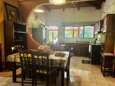 a kitchen with a table and some chairs and a kitchen with a table at Cantarrana Countryside Villa with private pool