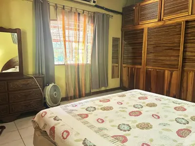 a bedroom with a bed and a dresser and a window at Cantarrana Countryside Villa with private pool
