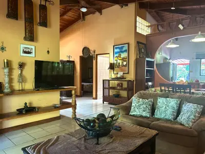 a living room with a couch and a tv at Cantarrana Countryside Villa with private pool