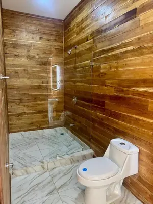 a bathroom with a toilet and a glass shower at Villa Republik in Parrita