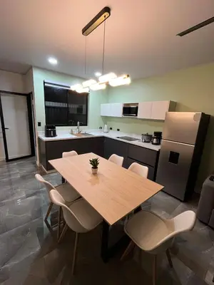 a large kitchen with a wooden table and chairs at Villa Esencia La Fortuna in Fortuna