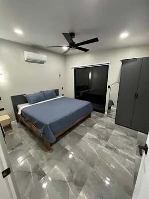 a bedroom with a bed and a ceiling fan at Villa Esencia La Fortuna in Fortuna