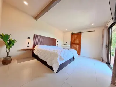 a bedroom with a large bed and a window at Silencio Verde in Atenas