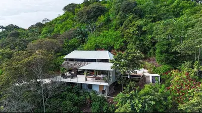 a house in the middle of a hill with trees at Silencio Verde in Atenas