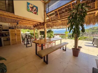 a dining room with a table and a plant at Silencio Verde in Atenas