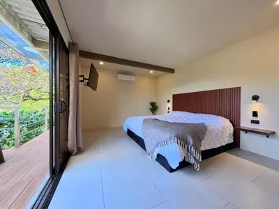 a bedroom with a bed and a large window at Silencio Verde in Atenas