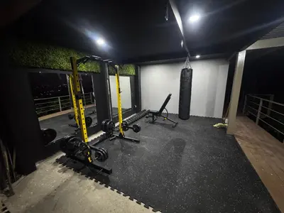 a gym with treadmills and weights in a room at Silencio Verde in Atenas