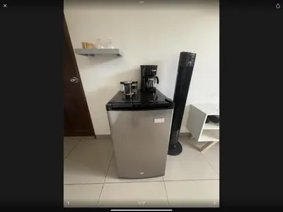 a trash can with a coffee maker in a room at PURA VIDA AIRPORT STAY FREE SHUTTLe in Alajuela City