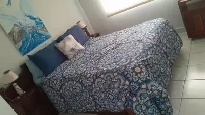 a bedroom with a bed with a quilt on it at Punta Leona, Sotavento 1 Plea Mar casita in Punta Leona