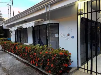 a building with a bunch of flowers in front of it at Punta Leona, Sotavento 1 Plea Mar casita in Punta Leona