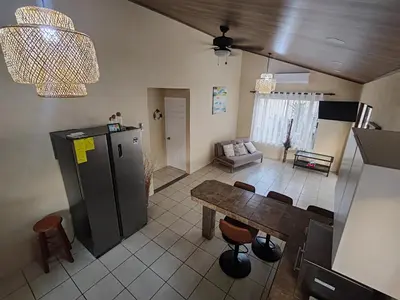 a kitchen with a table and a living room at Casa Tribu in Agujas