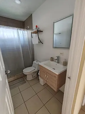 a bathroom with a toilet and a sink and a mirror at Casa Tribu in Agujas