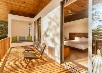 a master bedroom with a bed and a balcony at Nimbu East in Tamarindo