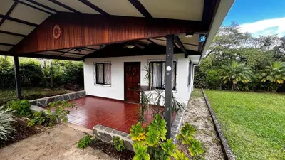 a small white house with a red brick porch at Casa Vegas Panoramic Views near Monteverde in Turín