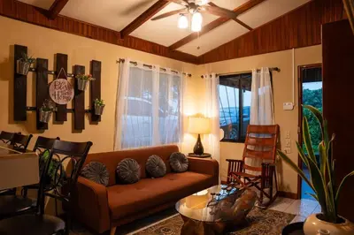 a living room with a couch and a table at Casa Vegas Panoramic Views near Monteverde in Turín