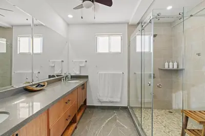 a bathroom with two sinks and a shower at Villa Costa Sota - Ocean View & Pickleball Courts in Coco