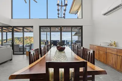 a dining room with a long table and chairs at Villa Costa Sota - Ocean View & Pickleball Courts in Coco