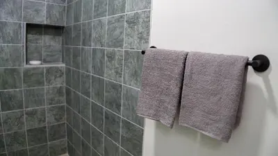 a bathroom with two towels hanging on a wall at Divan Jungle Lodge in Fortuna