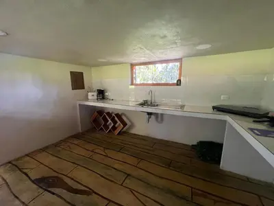 a kitchen with a counter and a sink in a room at Cabañita tipo Chalet in Fortuna