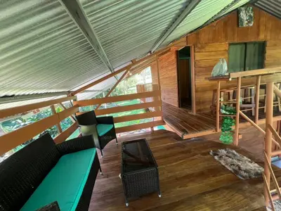 a living room of a wooden cabin with a couch at Cabañita tipo Chalet in Fortuna
