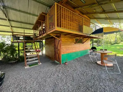 a tree house with a balcony and a table at Cabañita tipo Chalet in Fortuna