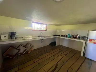 a kitchen with a counter and a sink and a refrigerator at Cabañita tipo Chalet in Fortuna