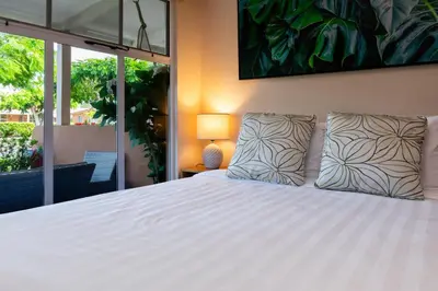 a bedroom with a white bed with two pillows at Jacó Cozy 1BR Pool AC Secure Near Beach in Jacó