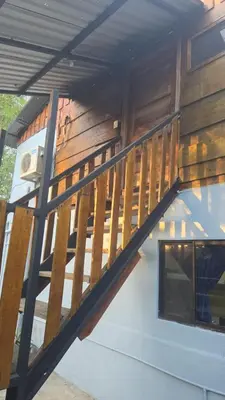 a wooden deck on the side of a house at Casa Passiflora - Playa Grande in Refundores