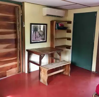 a wooden table and a bench in a room at Casa Passiflora - Playa Grande in Refundores