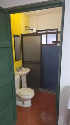 a bathroom with a toilet and a sink at Casa Passiflora - Playa Grande in Refundores