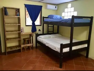 a bedroom with two bunk beds and a mirror at Casa Passiflora - Playa Grande in Refundores