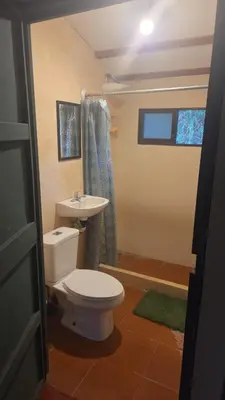a bathroom with a toilet and a sink at Casa Passiflora - Playa Grande in Refundores