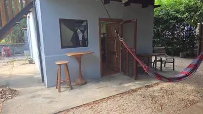 a house with a hammock outside of it at Casa Passiflora - Playa Grande in Refundores