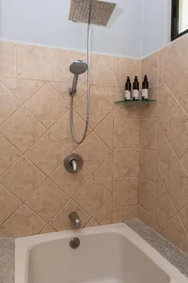 a shower in a bathroom with a tub at Corteza 2BD Gated AC Quiet Terrace Pools in Jacó
