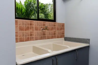 a large white sink in a bathroom with a window at Corteza 2BD Gated AC Quiet Terrace Pools in Jacó