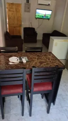 a kitchen with a table and chairs and a living room at Casas de Playa en Familia