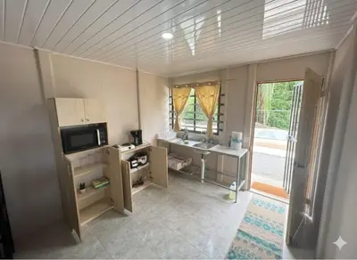 a living room with a television and a desk and a window at Casas de Playa en Familia