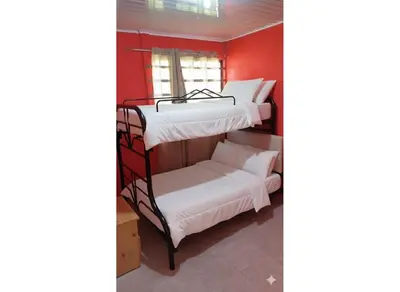 a room with two bunk beds and a window at Casas de Playa en Familia